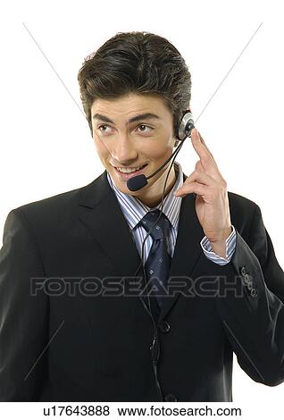 Stock Photo - Close-up of a businessman wearing a headset and smiling. Fotosearch