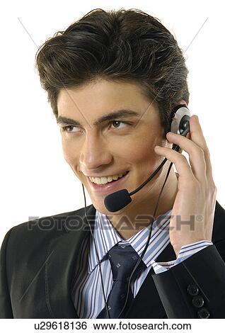 Close-up of a businessman wearing a headset and smiling View Large Photo Image Stock Photograph - Close-up of a businessman wearing a headset and smiling. Fotosearch