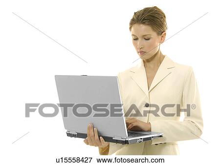 Close-up of a businesswoman working on a laptop View Large Photo Image Stock Photo - Close-up of a businesswoman working on a laptop. Fotosearch