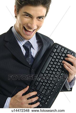 Portrait of a businessman holding a computer keyboard and laughing View Large Photo Image Stock Photo - Portrait of a businessman holding a computer keyboard and laughing. Fotosearch