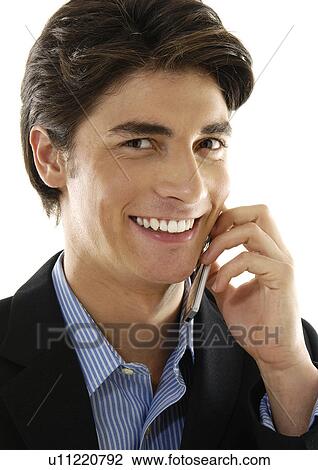 Portrait of a businessman talking on a mobile phone and smiling View Large Photo Image Stock Image - Portrait of a businessman talking on a mobile phone and smiling. Fotosearch