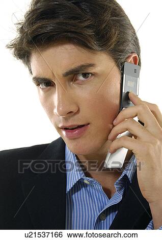 Portrait of a businessman talking on a mobile phone View Large Photo Image Stock Photograph - Portrait of a businessman talking on a mobile phone. Fotosearch