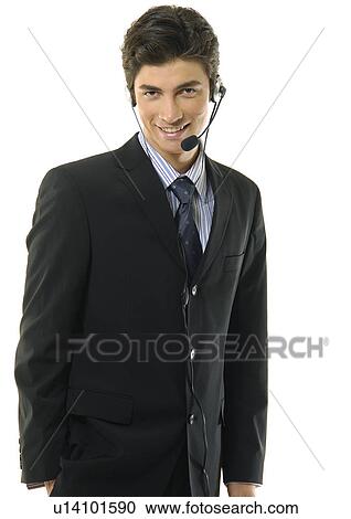 Stock Image - Portrait of a businessman wearing a headset and smiling. Fotosearch