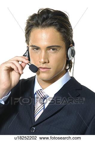 Portrait of a businessman wearing a headset View Large Photo Image Stock Image - Portrait of a businessman wearing a headset. Fotosearch