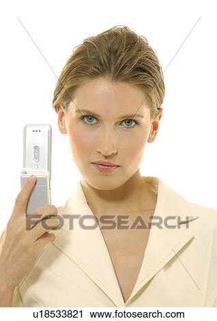 Stock Image - Portrait of a businesswoman holding a mobile phone. Fotosearch