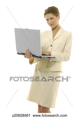 Portrait of a businesswoman working on a laptop and grinning View Large Photo Image Stock Image - Portrait of a businesswoman working on a laptop and grinning. Fotosearch