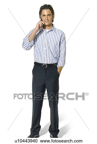 Portrait of a young man talking on a mobile phone and smiling View Large Photo Image Stock Image - Portrait of a young man talking on a mobile phone and smiling. Fotosearch