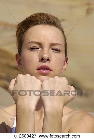Stock Photo - Close-up of a young woman practicing yoga. Fotosearch