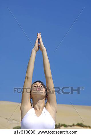 Close-up of a young woman practicing yoga in a prayer position View Large Photo Image Stock Photograph - Close-up of a young woman practicing yoga in a prayer position. Fotosearch