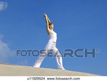 Side profile of a young woman practicing yoga View Large Photo Image Picture - Side profile of a young woman practicing yoga. Fotosearch