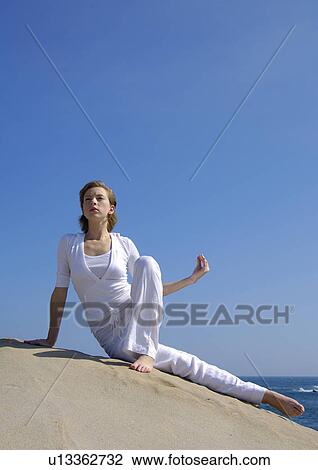 Young woman practicing yoga View Large Photo Image Stock Image - Young woman practicing yoga. Fotosearch