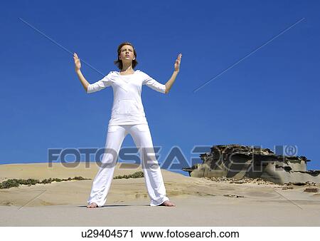 Young woman practicing yoga View Large Photo Image Stock Image - Young woman practicing yoga. Fotosearch
