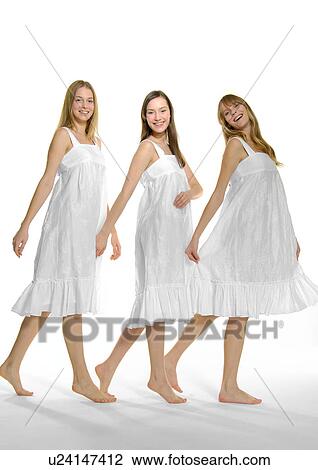 Stock Image - Portrait of three young women dancing. Fotosearch