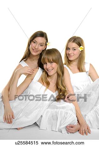 Portrait of three young women sitting together and smiling View Large Photo Image Stock Photography - Portrait of three young women sitting together and smiling. Fotosearch