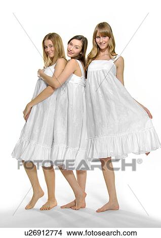 Picture - Portrait of three young women standing together. Fotosearch