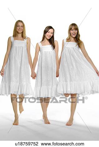 Portrait of three young women standing with holding each other's hands View Large Photo Image Stock Image - Portrait of three young women standing with holding each other's hands. Fotosearch
