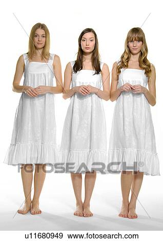 Portrait of three young women standing together View Large Photo Image Stock Photo - Portrait of three young women standing together. Fotosearch