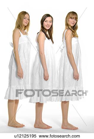 Side profile of three young women standing together in a row View Large Photo Image Stock Photography - Side profile of three young women standing together in a row. Fotosearch
