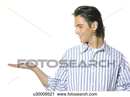 Close-up of a young man looking towards his right hand View Large Photo Image Stock Image - Close-up of a young man looking towards his right hand. Fotosearch