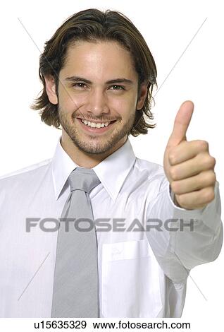 Portrait of a businessman making a thumbs up sign and smiling View Large Photo Image Stock Photo - Portrait of a businessman making a thumbs up sign and smiling. Fotosearch