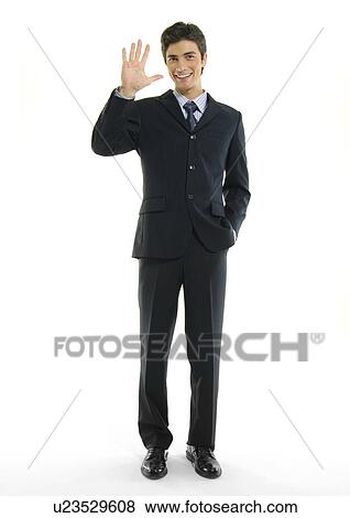 Portrait of a businessman making a stop gesture and smiling View Large Photo Image Stock Photo - Portrait of a businessman making a stop gesture and smiling. Fotosearch