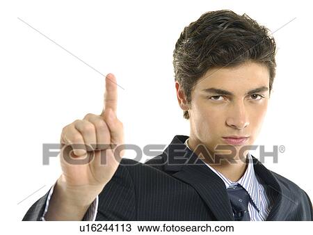 Portrait of a businessman pointing and looking serious View Large Photo Image Stock Image - Portrait of a businessman pointing and looking serious. Fotosearch