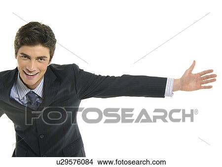 Portrait of a businessman standing with his arm outstretched View Large Photo Image Picture - Portrait of a businessman standing with his arm outstretched. Fotosearch