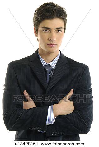 Portrait of a businessman standing with his arms crossed View Large Photo Image Stock Image - Portrait of a businessman standing with his arms crossed. Fotosearch