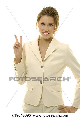 Portrait of a businesswoman making a peace sign and smiling View Large Photo Image Stock Photography - Portrait of a businesswoman making a peace sign and smiling. Fotosearch