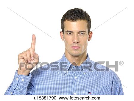 Stock Image - Portrait of a young man gesturing and looking serious. Fotosearch