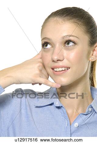 Stock Photograph - Close-up of a young woman showing call me gesture. Fotosearch