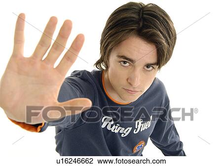Stock Image - Portrait of a young man making a stop gesture. Fotosearch