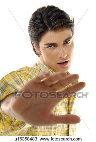 Portrait of a young man making a stop gesture View Large Photo Image Stock Image - Portrait of a young man making a stop gesture. Fotosearch