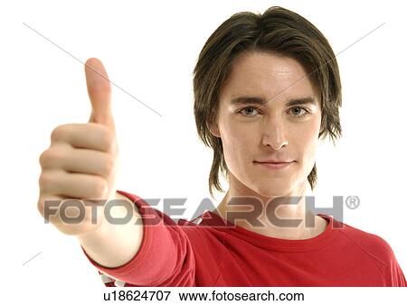 Portrait of a young man making a thumbs up sign View Large Photo Image Stock Photo - Portrait of a young man making a thumbs up sign. Fotosearch