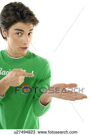 Portrait of a young man pointing towards his palm View Large Photo Image Stock Image - Portrait of a young man pointing towards his palm. Fotosearch