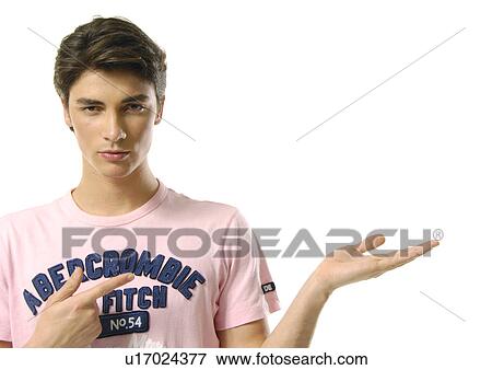 Portrait of a young man pointing sideways View Large Photo Image Stock Photo - Portrait of a young man pointing sideways. Fotosearch