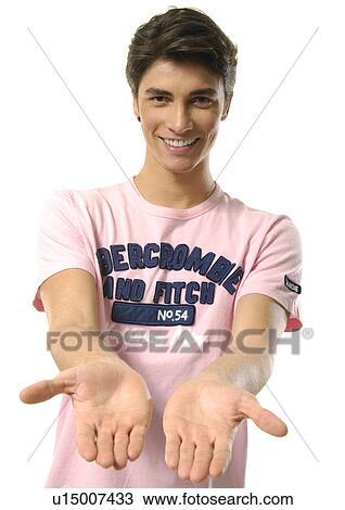 Stock Image - Portrait of a young man showing his palms. Fotosearch
