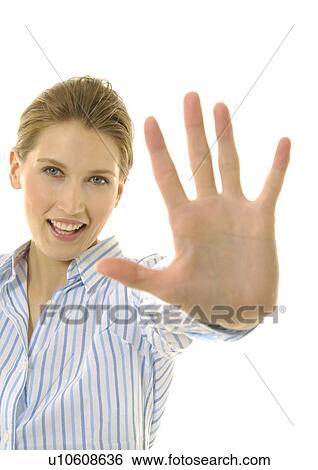 Portrait of a young woman making a stop gesture and smiling View Large Photo Image Stock Photograph - Portrait of a young woman making a stop gesture and smiling. Fotosearch
