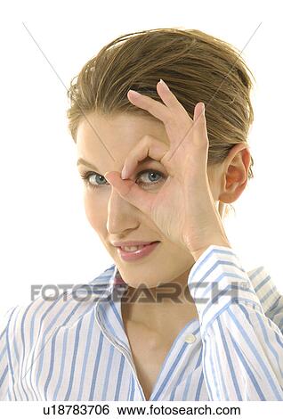 Portrait of a young woman making an ok sign View Large Photo Image Stock Photograph - Portrait of a young woman making an ok sign. Fotosearch