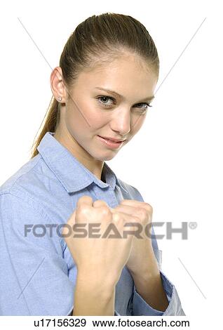 Stock Photo - Portrait of a young woman making fist. Fotosearch