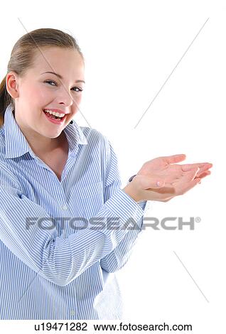 Portrait of a young woman standing with her hands cupped and listening to music View Large Photo Image Stock Image - Portrait of a young woman standing with her hands cupped and listening to music. Fotosearch