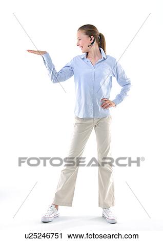 Young woman listening to music and looking towards her palm View Large Photo Image Stock Image - Young woman listening to music and looking towards her palm. Fotosearch