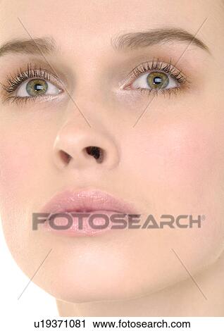 Stock Image - Close-up of a young woman looking up. Fotosearch