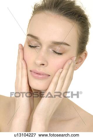 Close-up of a young woman with her eyes closed View Large Photo Image Stock Photo - Close-up of a young woman with her eyes closed. Fotosearch
