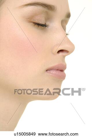 Stock Photo - Close-up of a young woman with her eyes closed. Fotosearch