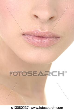 Close-up of a young woman with her lips View Large Photo Image Stock Photo - Close-up of a young woman with her lips. Fotosearch
