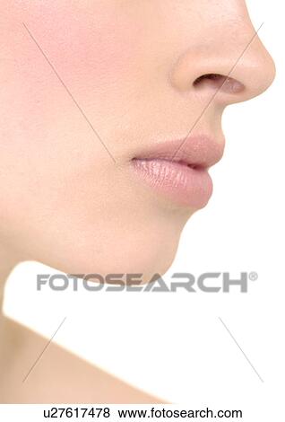 Close-up of a young woman with her lips View Large Photo Image Stock Photo - Close-up of a young woman with her lips. Fotosearch