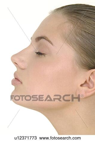 Close-up of a young woman with her eyes closed View Large Photo Image Stock Image - Close-up of a young woman with her eyes closed . Fotosearch