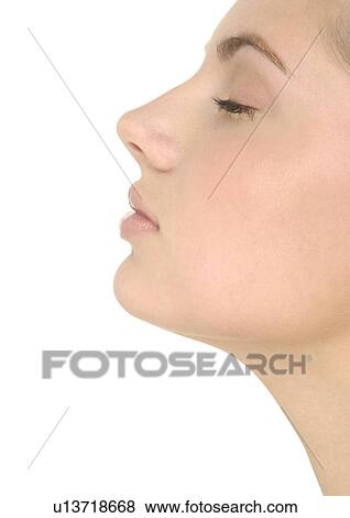 Stock Photo - Close-up of a young woman with her eyes closed. Fotosearch