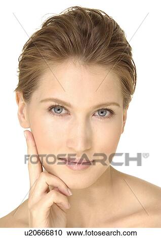 Portrait of a young woman with her hand on her chin View Large Photo Image Stock Image - Portrait of a young woman with her hand on her chin. Fotosearch